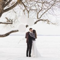 Bräutigam und Braut küssen sich im Winter