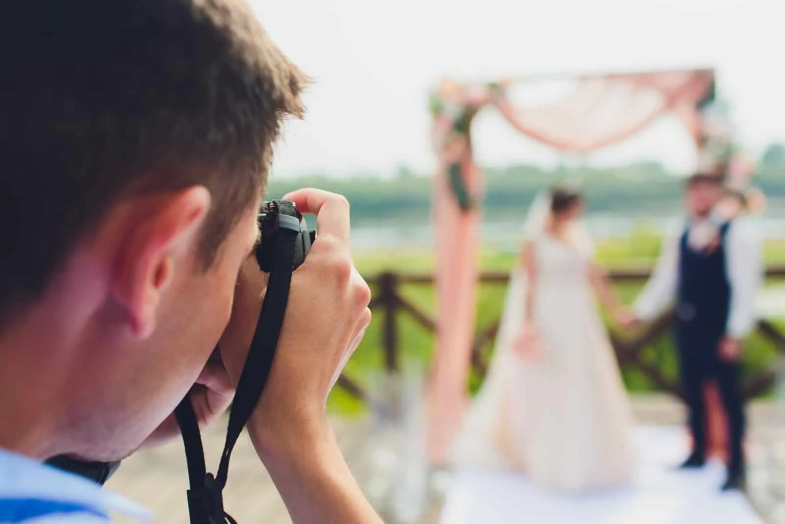 Der Fotograf fotografiert die Hochzeit des Brautpaares