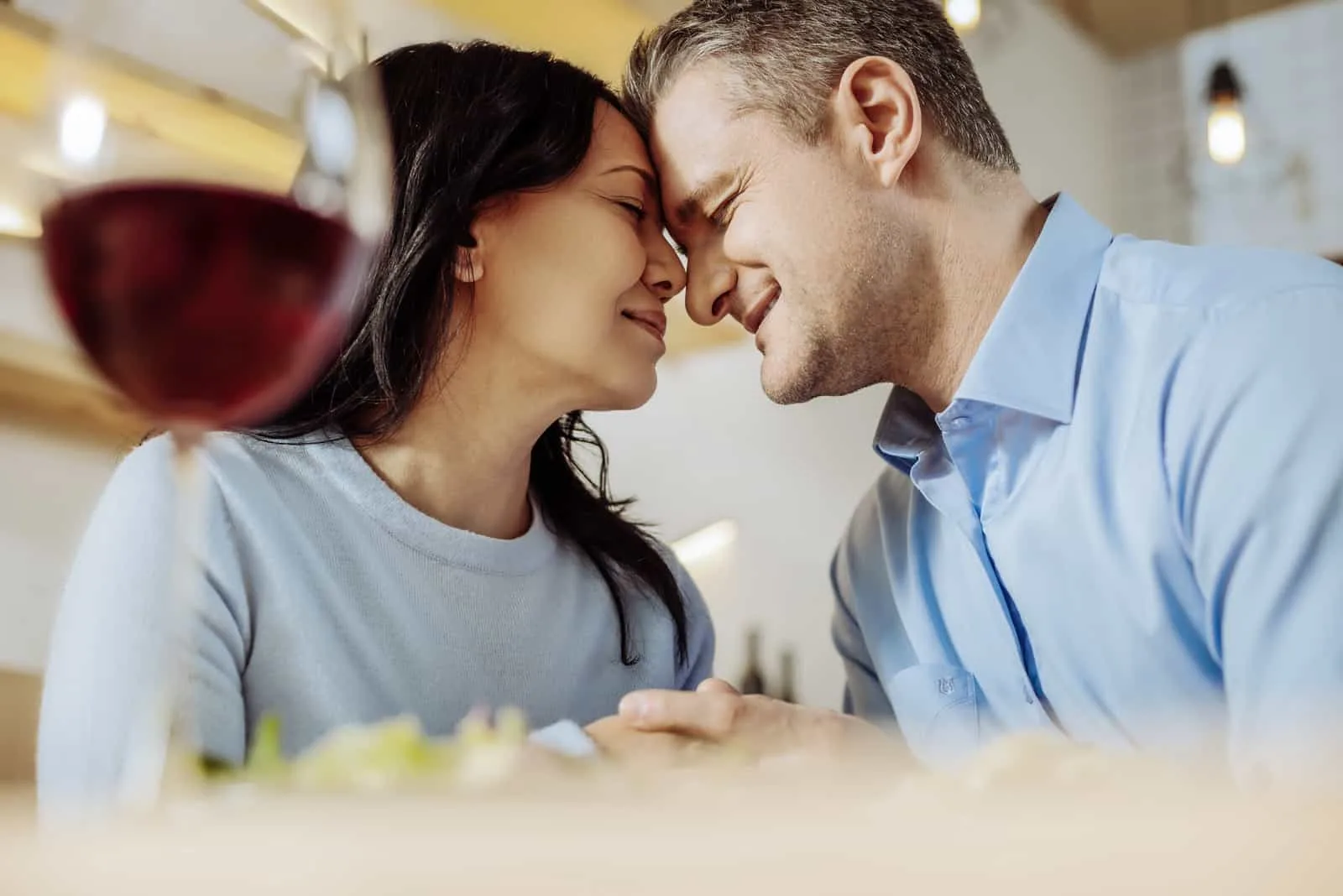 ein verliebtes Paar, das am Wein umarmt sitzt